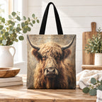 One vintage Highland cow tote bag with black handles, styled on pale timber with ivory linen and eucalyptus. Sold individually; props not included.
