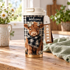 White-lid Highland cow travel cup on a country kitchen table with sage linen; styling props are not included.