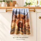 Realistic Highland cow tea-towel size guide showing one towel approximately 43 × 66 cm. Sold individually.