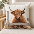 Seated Cow design: a seated Highland cow behind a low wooden rail on a 45 × 45 cm cushion cover. Insert not included.