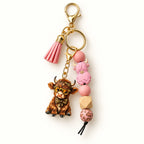 Pink Highland cow beaded tassel keyring with glasses-wearing calf charm and leopard-pattern details