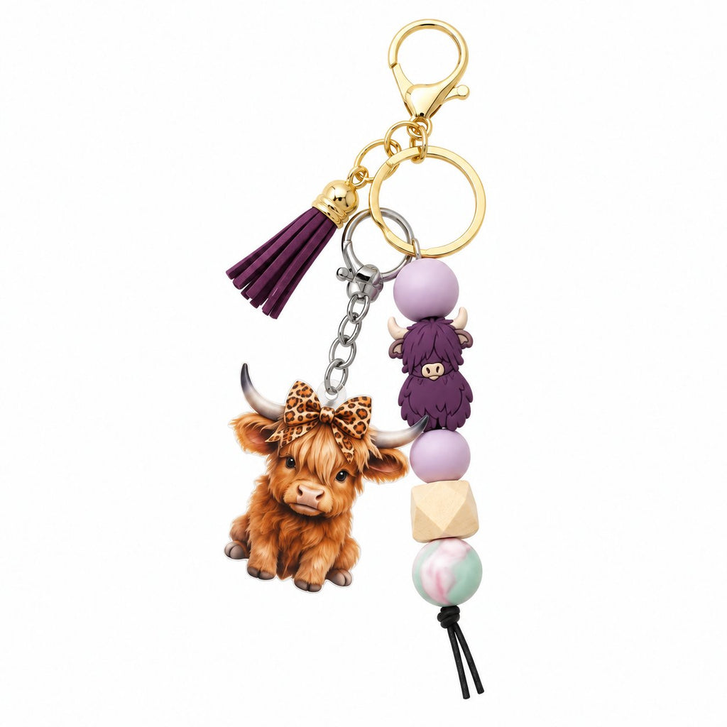 Purple Highland cow beaded tassel keyring with leopard-bow calf charm and gold-tone clasp