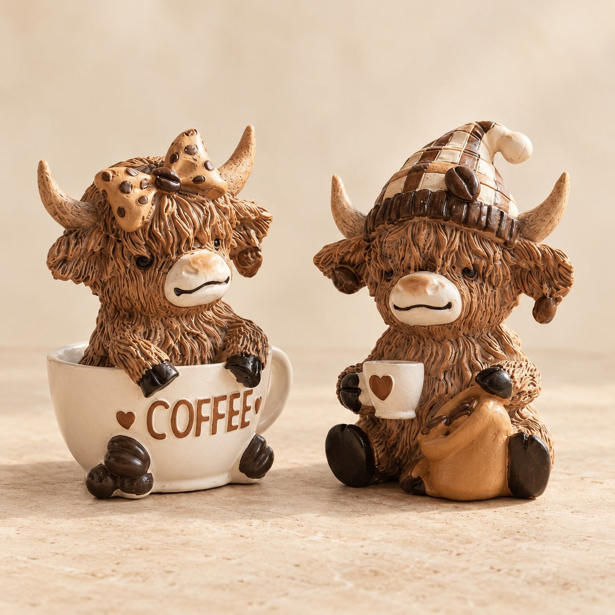 Two Highland cow coffee ornament designs shown together: Coffee Cup and Coffee Beans. Each figurine is sold separately.