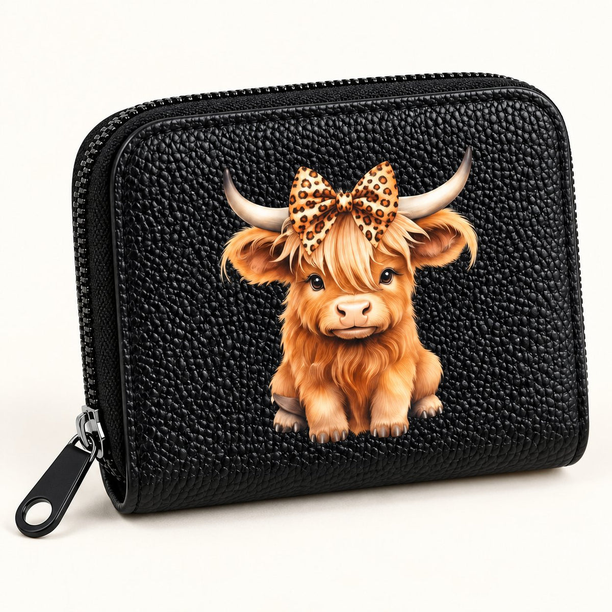 Close-up of Highland cow leopard bow print and textured pink PU card holder