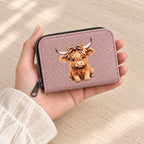 Pink Highland cow card holder held in a hand to show its compact size