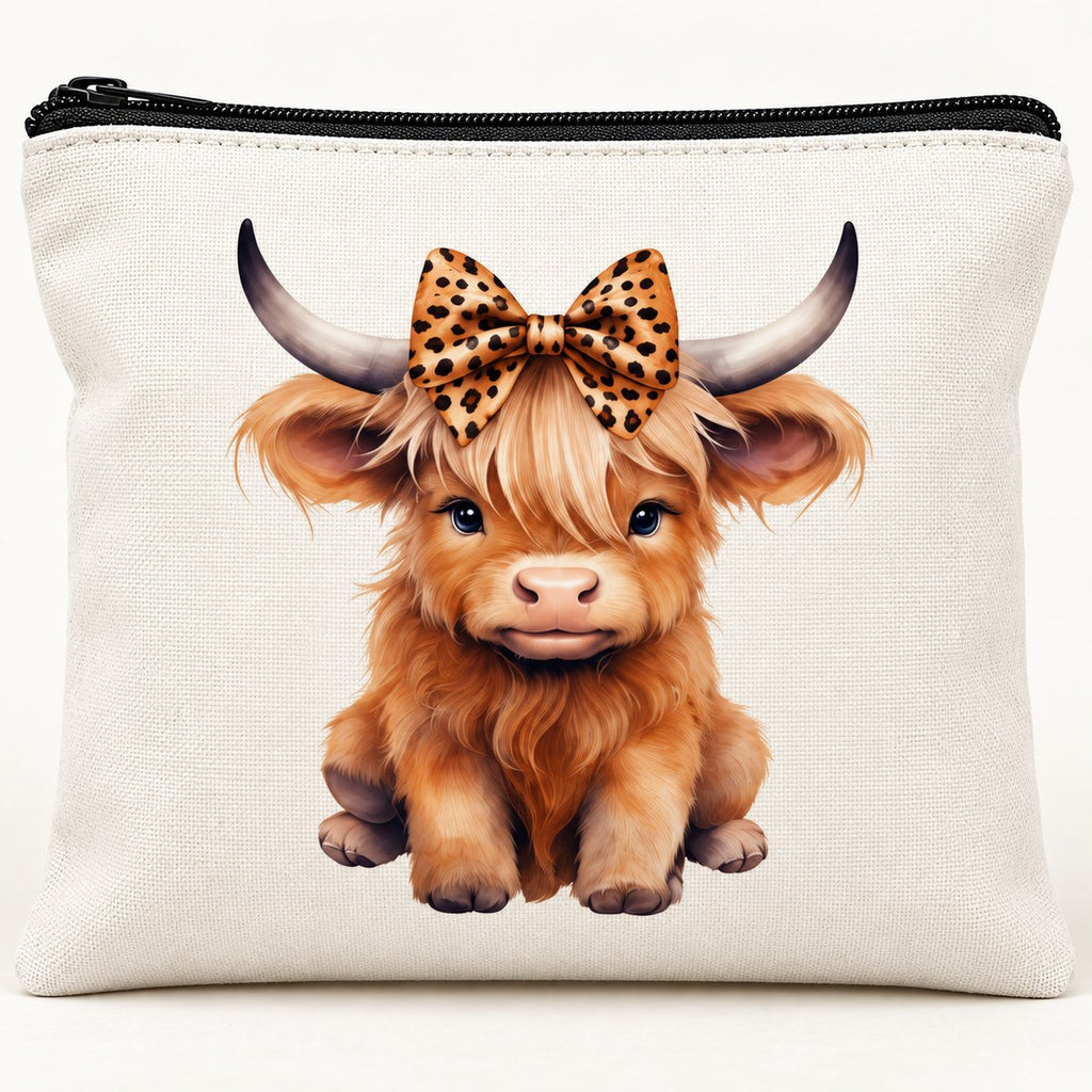 Close-up of leopard bow Highland cow print, white polyester fabric and black zip