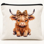 Close-up of leopard bow Highland cow print, white polyester fabric and black zip
