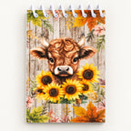Close-up of the Highland calf and sunflower artwork on a mini notebook with white top spiral binding