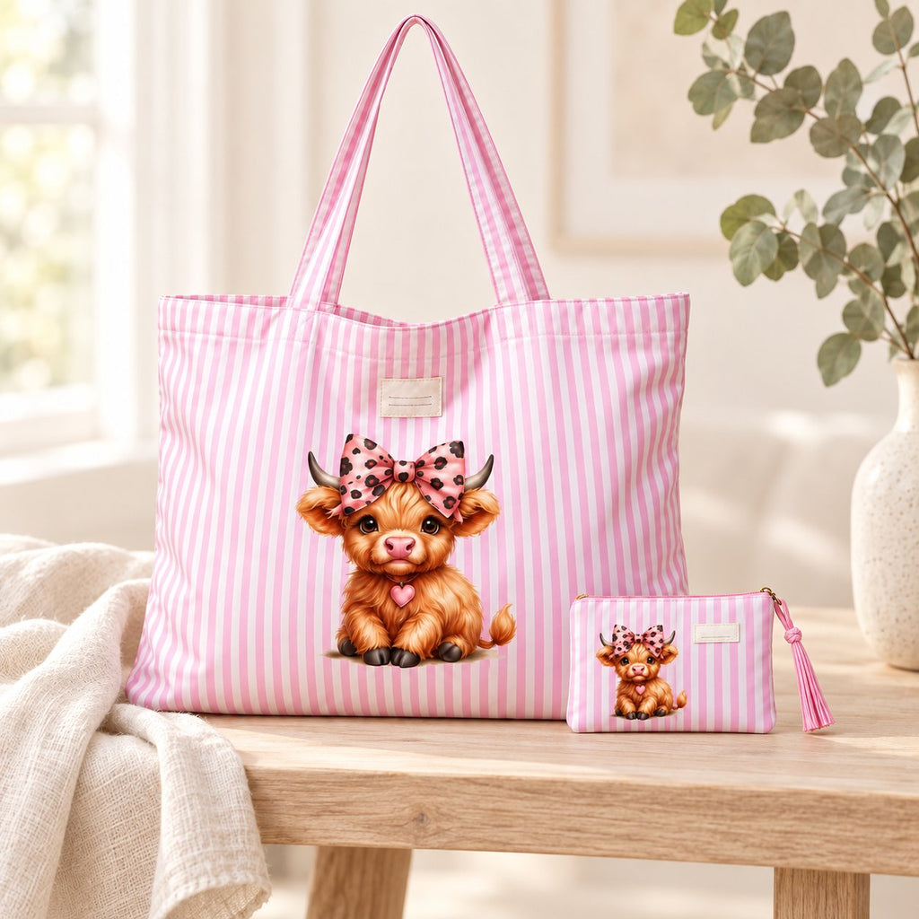 Pink striped Highland cow tote and small matching purse styled on pale timber with cream linen and eucalyptus; decorative props are not included.