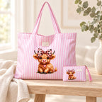 Pink striped Highland cow tote and small matching purse styled on pale timber with cream linen and eucalyptus; decorative props are not included.