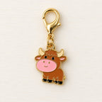 Close-up of brown calf charm with pink muzzle, cream horns and gold-coloured clasp