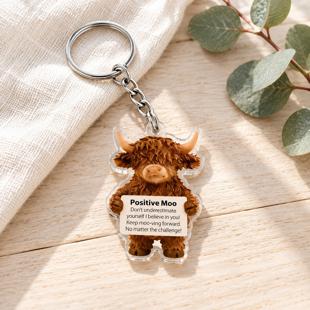 Positive Moo Highland Cow Acrylic Keyring. lifestyle.