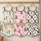 Pink Cow, Black Bow and Sunflower ladies pyjamas displayed on wooden hangers