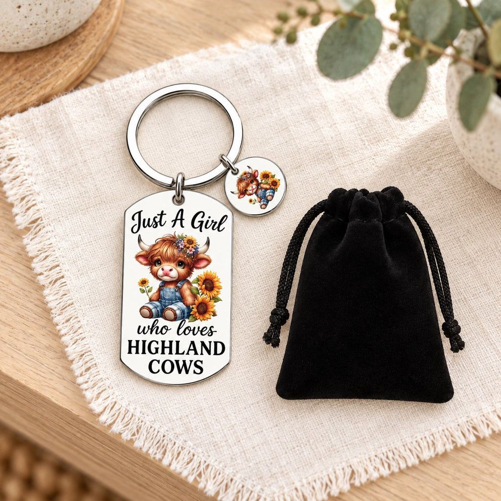 Highland cow keyring and included black gift bag styled on ivory linen and pale timber