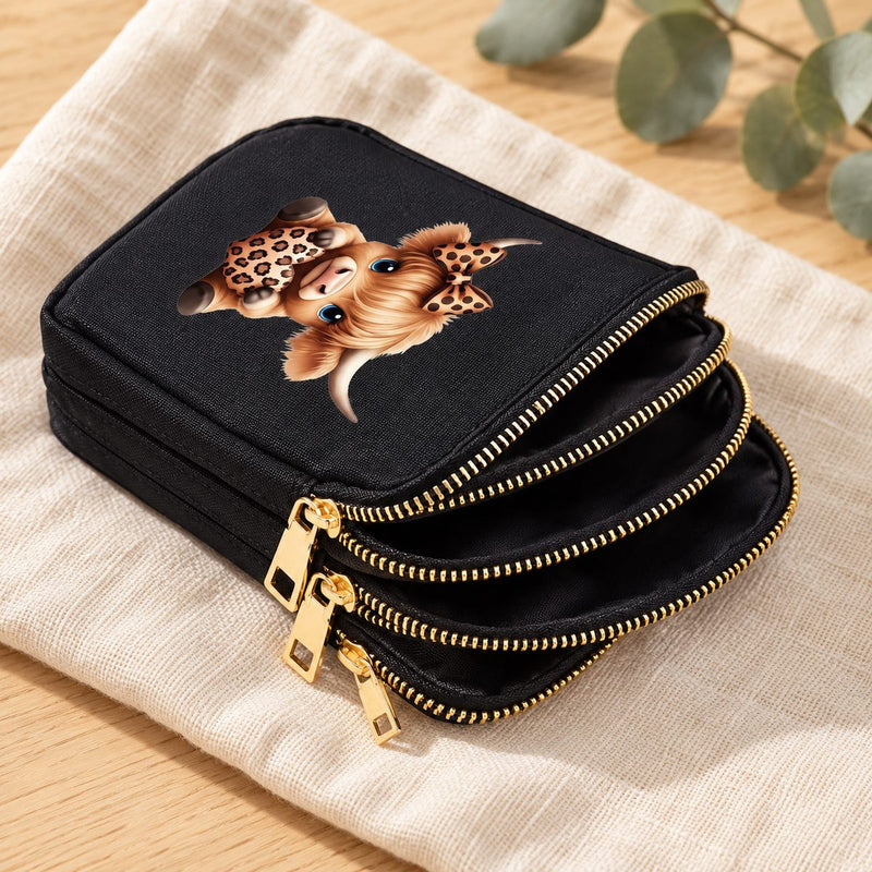 Inside the Leopard Bow Highland cow bag, showing its three zipped compartments and black lining