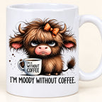 Close-up of the grumpy Highland calf and I’m Moody Without Coffee print on the ceramic mug.