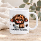 Moody Without Coffee Highland cow mug styled on pale timber with ivory linen and greenery; decorative props not included.