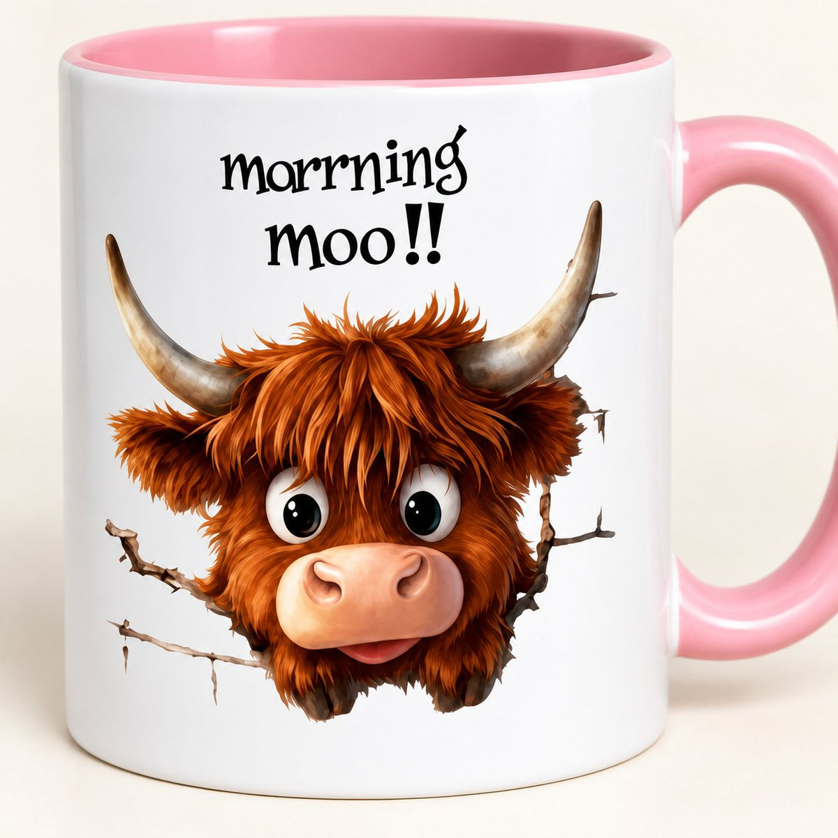 Close-up of the wide-eyed Highland cow and printed Morning Moo design on the pink-handled ceramic mug.