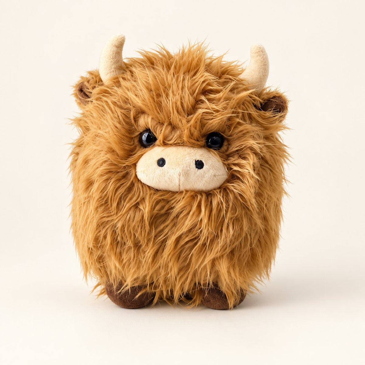 Brown shaggy Highland cow plush with cream horns, beige muzzle and tiny brown hooves