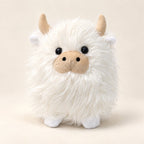 White shaggy Highland cow plush with cream horns, beige muzzle and tiny white hooves