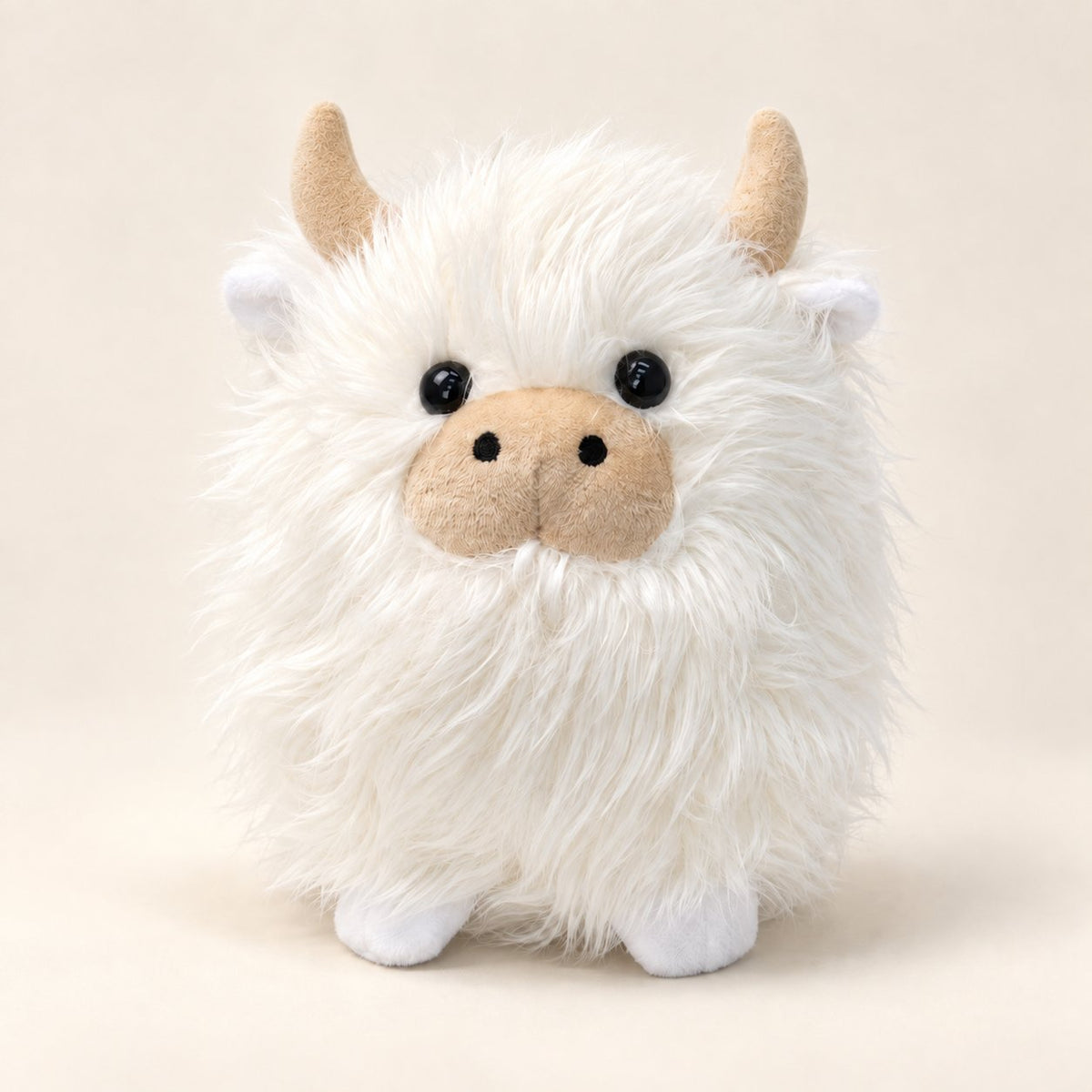 White shaggy Highland cow plush with cream horns, beige muzzle and tiny white hooves