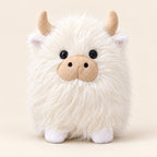 White shaggy Highland cow plush, approximately 22 cm, with cream horns and a beige muzzle on an ivory background. Sold individually.