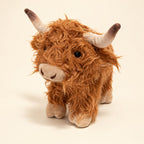Brown standing Highland cow plush with curly fur, cream horns with dark tips and beige hooves