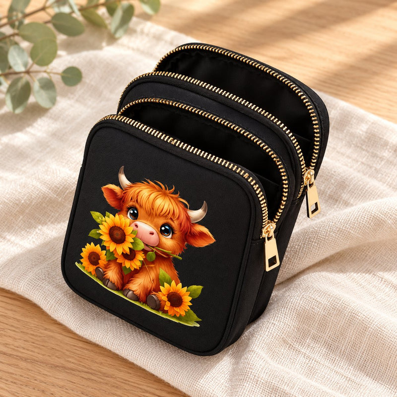 Inside the Sunflower Highland cow bag, showing its three zipped compartments and black lining