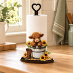 Sunflower Highland cow kitchen roll holder styled on a warm oak kitchen counter